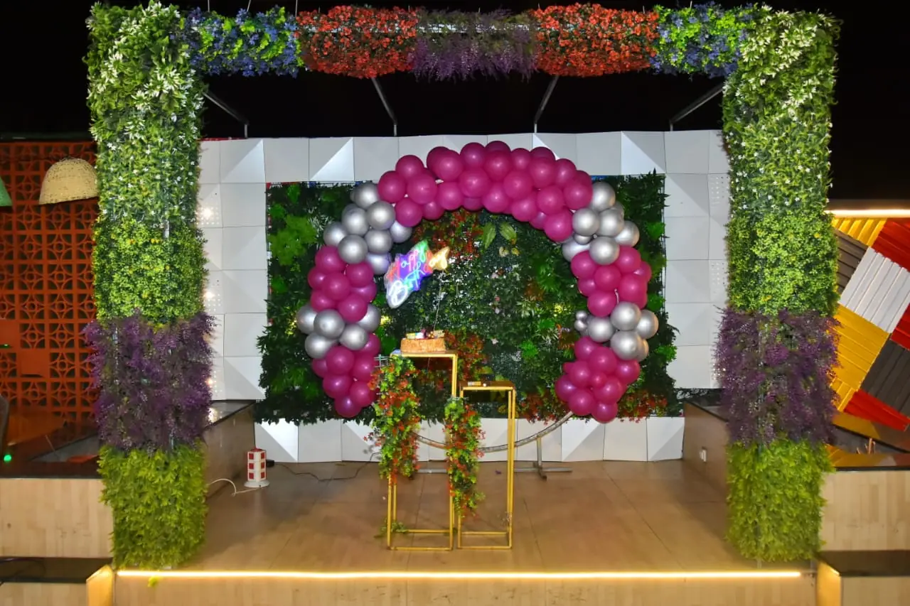 Magenta and silver balloon arch at JD Sky Dine rooftop